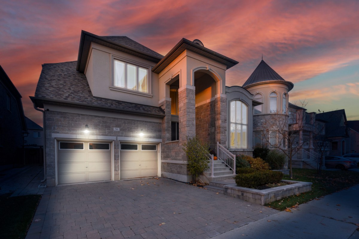 Two-storey stone house in Vaughan at dusk, where the building permit cost in Ontario follows Vaughan's own fee schedule rather than Toronto's