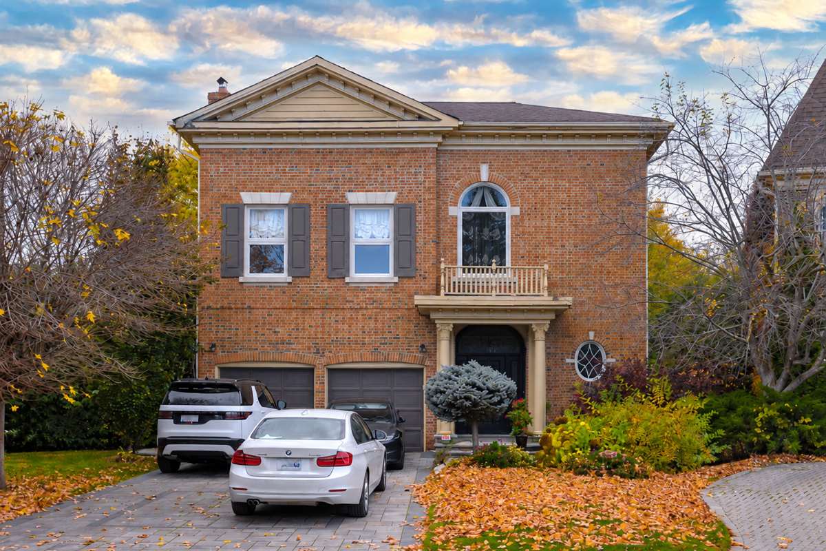 Two-storey brick house with arched and rectangular windows, where any new window opening in the brick wall needs a lintel detail and a permit