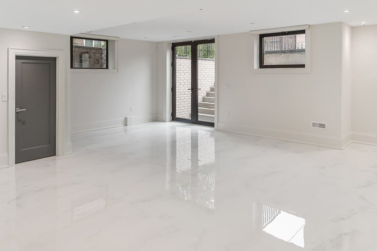Bright finished basement with a walk-up door and above-grade windows, showing the entrance and window details a second unit drawing set has to include